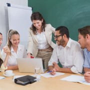 Casual business team having a meeting using laptop