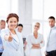 businesswoman in office showing thumbs up